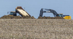 Dead chickens are buried in a farm field in Iowa in May 2015. (Rodney White/The Des Moines Register via AP) 