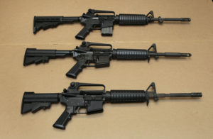 In this Aug. 15, 2012 file photo, three variations of the AR-15 assault rifle are displayed. While the guns similar, the bottom version is illegal in California because of its quick reload capabilities. Omar Mateen used an AR-15 that he purchased legally when he killed 49 people in an Orlando nightclub. . (AP Photo/Rich Pedroncelli,file)