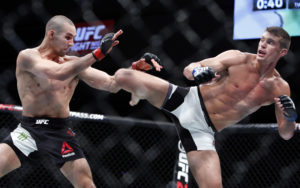 Stephen Thompson, right, kicks to the body of Rory MacDonald during a welterweight bout at UFC Fight Night 89 in Ottawa, Ontario on Sunday, June 19, 2016. (Fred Chartrand/The Canadian Press via AP) 