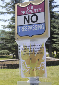 A sign at the National Weather Service in Anchorage, Alaska, informs Pokemon players that it's illegal to trespass on federal property. The staff started noticing an uptick of people in the parking lot after the location was included as a gym in the popular game. (AP Photo/Mark Thiessen)