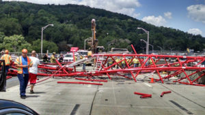 A giant crane sits road bed of the Tappan Zee Bridge north of New York City after toppling around noon on Tuesday, July 19, 2016, during construction of a new bridge, across the Hudson River between Westchester and Rockland counties. The base and treads of the huge, moveable crane sat on the unfinished new bridge while part of the toppled crane lay across the lanes of the old bridge and another section lay across a construction platform in the water between the two spans. (David Leibstein via AP)