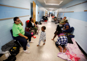 Residents of Charleston, S.C. occupy a school hallway at a shelter ahead of the arrival of Hurricane Matthew, in North Charleston, South Carolina October 6, 2016. REUTERS/Jonathan Drake