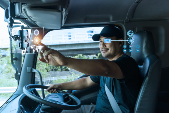 Asian truck drivers locate their position on digital map, realistically displayed on touch screen. concept Navigation technology, face detection, driver eye scan for safe transportation and delivery