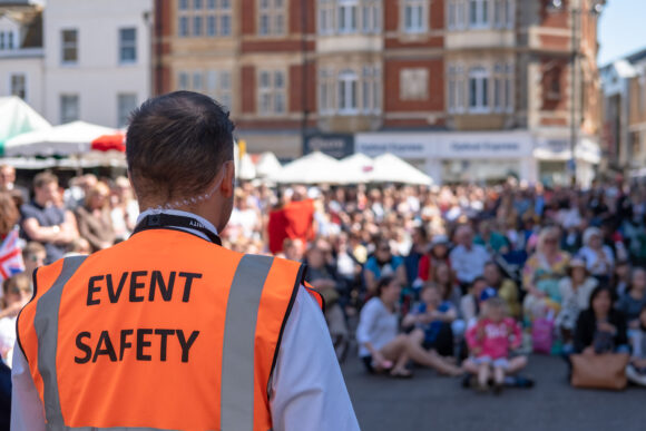 Shallow focus of an Event Safety officer seen facing members of