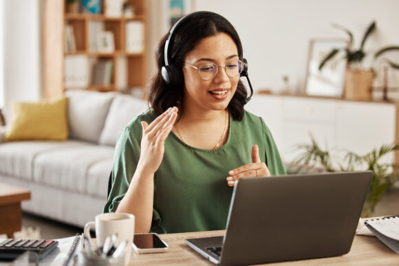 Home customer support, laptop video call and woman explain consultation, ecommerce or sales pitch in webinar. Freelance, remote work receptionist or person consulting on online conference discussion.
