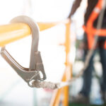 Industrial Worker with safety protective equipment loop hanging