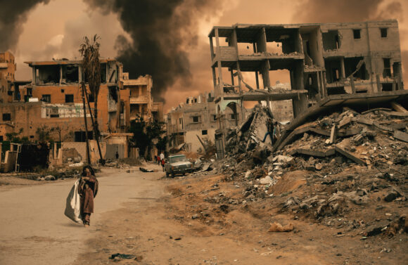 Homeless little girl walking in destroyed city that was bombed b