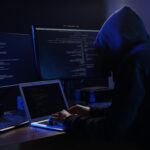 Hacker with computers in dark room. Cyber crime