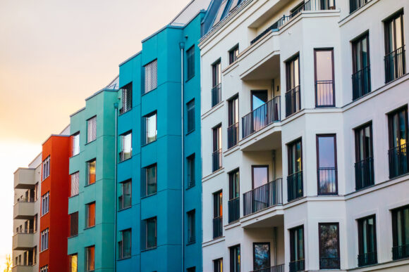 white, blue and red colored buildings in a row