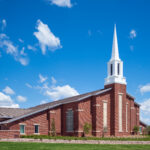 Mormon church against blue sky and white clouds