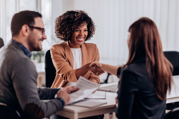 Woman shaking hands after successful job interview