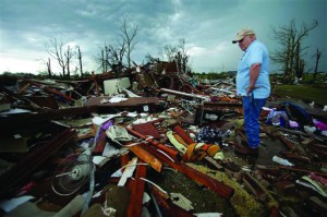 Monty Montgomery surveys the scene as he prepares to clean up a friend's tornado-ravaged home May 23, 2013, in Moore, Okla.  (AP Photo/Charlie Riedel)